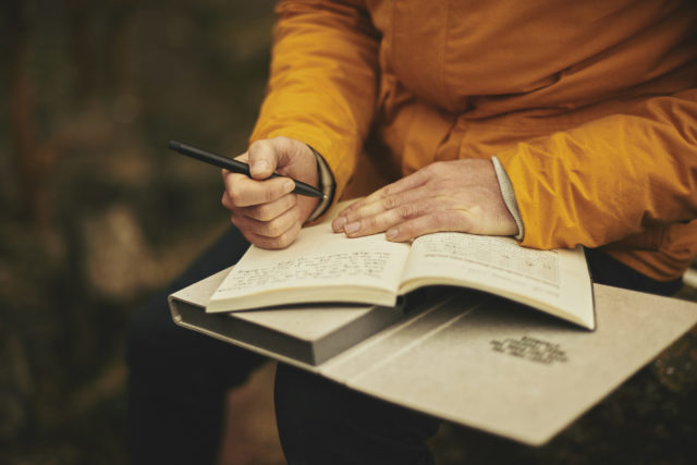 man-in-yellow-writing